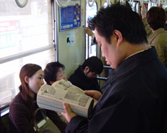 Reading manga on train in Japan